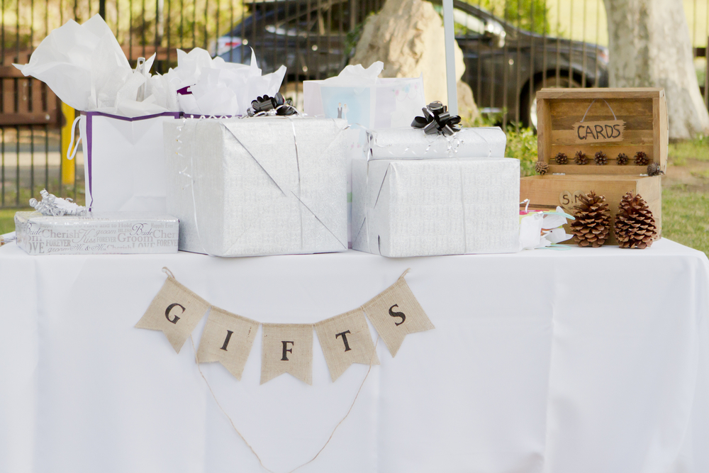 Cards and wedding gifts on a white table