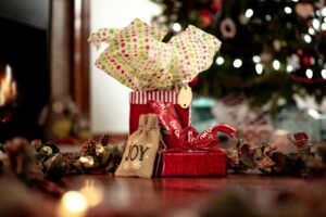 A collection of christmas gifts in front of a christmas tree